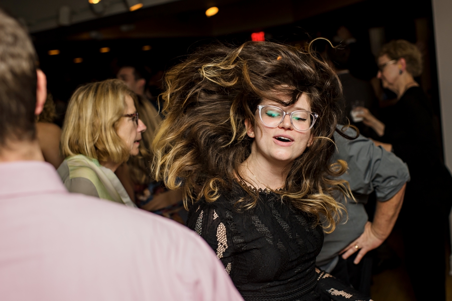 A woman with wild hair dancing at a wedding reception in Philadelphia.